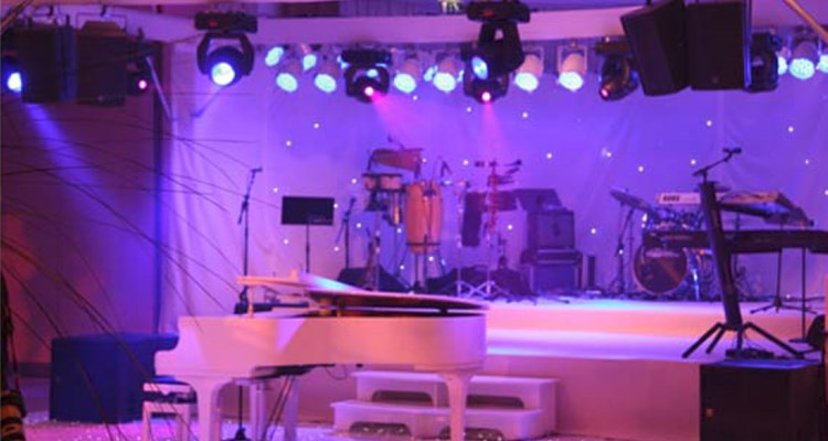 Purple lit stage and piano